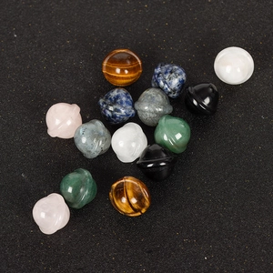 Set of mini natural gemstone planet carvings including rose quartz and tiger eye stones