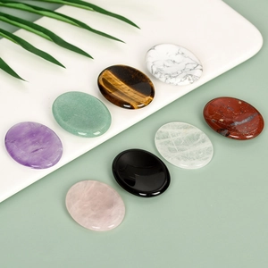 Polished natural oval thumb stones in crystal quartz and green aventurine for meditation