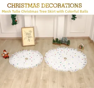 Detailed view of white pleated tulle Christmas tree skirt with vibrant colorful pompoms
