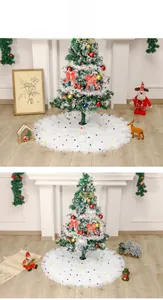 Detailed view of white tulle tiered Christmas tree skirt with colorful pom-poms
