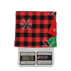 Macro view showing 92g weight of Christmas chair cover with red plaid and snowflake embroidery