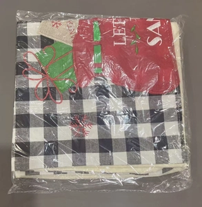 Detail of Christmas chair cover in black and white plaid with festive red applique designs