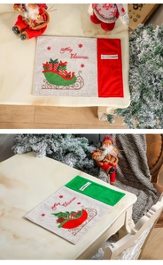 Detail of Christmas placemats with utensil pocket and Merry Christmas embroidery