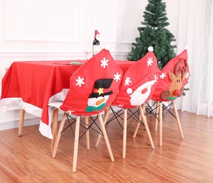 Detailed interior view of 3D Santa, Snowman and Reindeer non-woven chair covers on a festive table