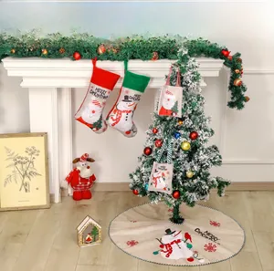 Detailed view of linen Christmas tree skirt with snowman print and green striped edges