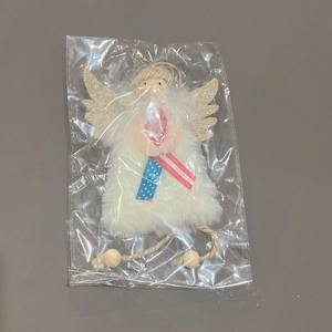 Détail d'ange en peluche avec ruban drapeau américain et ailes à paillettes dorées