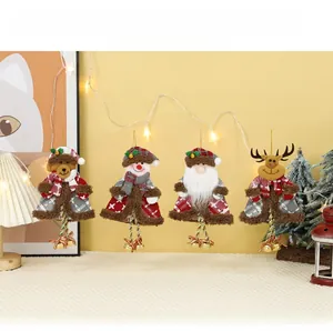 Detail of plush Christmas tree ornaments featuring Santa, snowman, and reindeer with bells