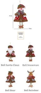 Detailed view of plush Christmas ornaments featuring Santa, snowman and reindeer with bells