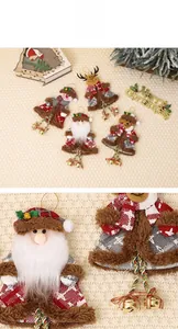 Detail of plush Christmas tree ornaments featuring Santa, snowman, deer, and bells
