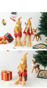 Detailed view of couple Christmas gnomes with long legs holding cutlery on festive background