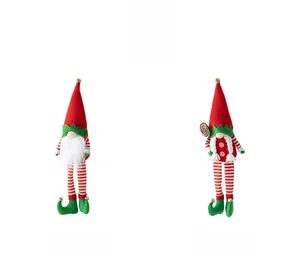 Detail of plush Christmas gnomes with striped hats and bells in red, green and white colors