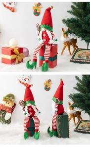 Close-up of Christmas gnome plush set with long legs and striped hats in festive scene