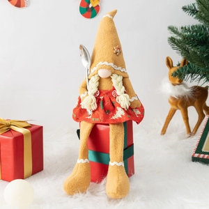 Gingerbread Christmas gnome doll with long legs and hat on red gift box decor