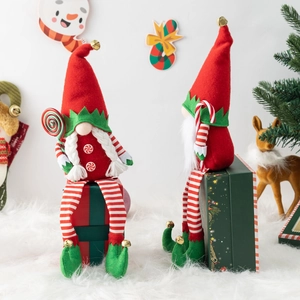 Set of two red and green Christmas gnomes with striped legs and candy cane accessories