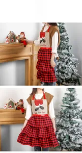 Detail of red plaid Christmas apron with layered ruffles and Santa boot print