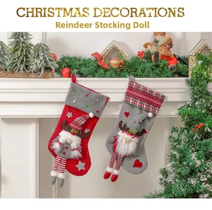 Detail view of gnome plush Christmas stockings hanging on fireplace with striped long legs