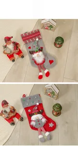 Detailed view of grey and red Christmas gnome stockings on rustic wooden background