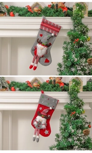 Detail of grey and red Christmas stockings with 3D gnomes and reindeer antlers decor