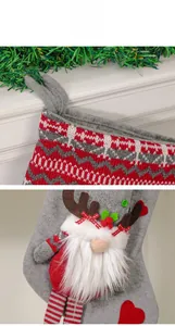 Detail of Christmas stocking with 3D gnome decor and knitted cuff on mantel background