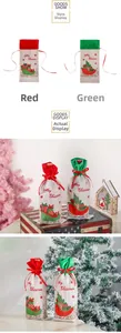 Detail of red and green burlap Christmas wine bottle bags with festive holiday patterns