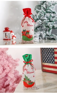 Detail of burlap Christmas wine bottle bags with Merry Christmas prints and ribbon ties