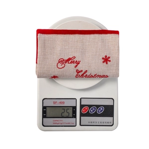 Close-up of 25g Christmas wine bottle bag on scale showing lightweight linen fabric