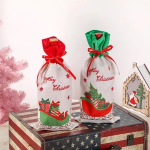Set of two canvas Christmas wine bottle bags with festive sleigh print and red silk bows