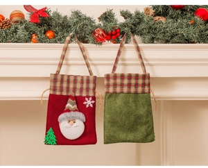 Detailed view of red Santa Claus gift bag with knit textures and Christmas decorations