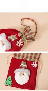 Detail of red felt Christmas gift bag with Santa Claus 3D decor and drawstring closure