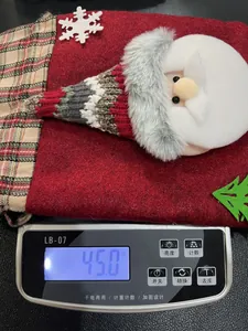 Detail of Christmas gift bag with Santa Claus 3D figure and weight 45g shown on scale