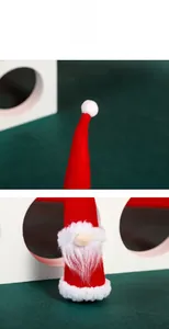 Detailed close-up of a red felt Christmas gnome ornament with white fluffy beard and nose
