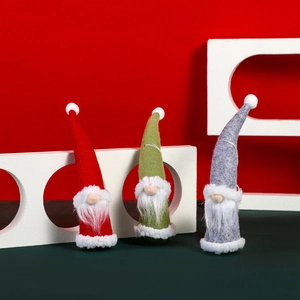 Three Christmas gnome ornaments in red green and grey felt with long white beards