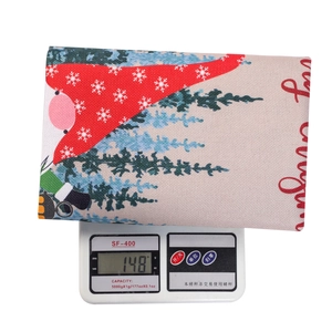 Close-up of linen Christmas gift bag with faceless doll pattern showing 148g weight