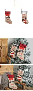 Detail of red and black plaid Christmas stockings with Santa Claus and hanging loops