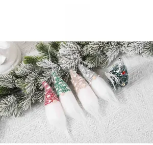 Set of four knitted Christmas gnomes with polka dot hats and white hanging ropes