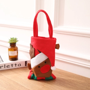Close-up of a festive Christmas reindeer gift bag made of red felt with a holiday hat decoration
