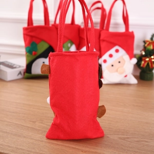 Detail of red Christmas felt gift bag featuring festive reindeer and santa claus characters