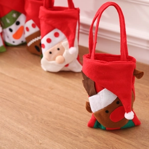 Close-up of festive Christmas gift bags with 3D Santa, Reindeer, and Snowman appliques