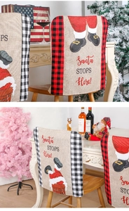 Close-up of rustic Christmas chair cover with red plaid trim and Santa Claus print
