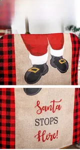 Detail of Christmas chair cover showing burlap texture and Santa Stops Here embroidery