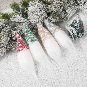 Set of four knitted Christmas gnomes with white beards and snow-dotted hats for tree decor