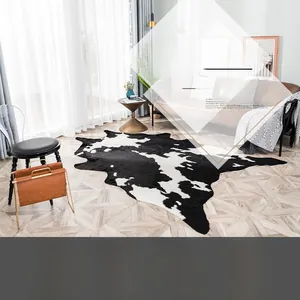 Detailed view of the soft velvet faux cowhide rug on light wooden flooring