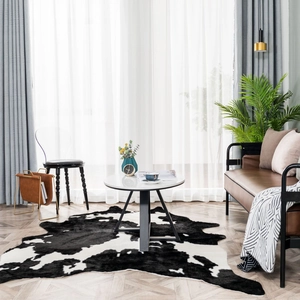 Faux cowhide rug with black and white spotted plush texture for living room decor