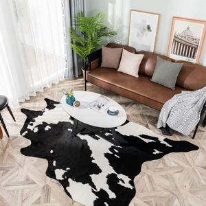 Faux cowhide rug in black and white pattern for modern living room decor