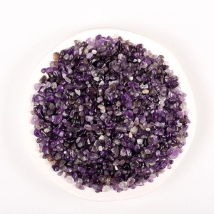 Polished natural amethyst crystal gravel for aromatherapy and decor on a white plate