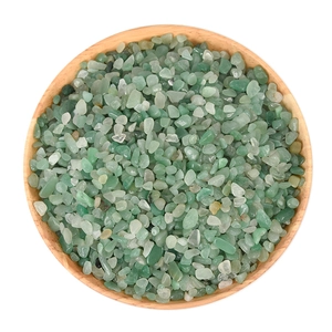 Natural Green Aventurine healing crystal stones in a round wooden bowl on white background