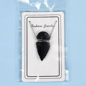 Handcrafted natural obsidian arrowhead pendant with silver wire wrap and chain on card