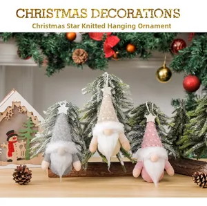 Three knitted Christmas gnomes with gold stars and hanging loops in festive background