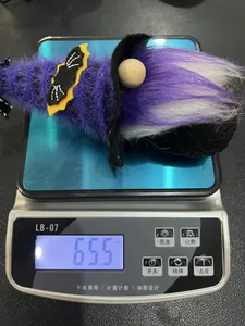 Detail showing a 65.5g purple Halloween gnome plush on a digital scale for weight display