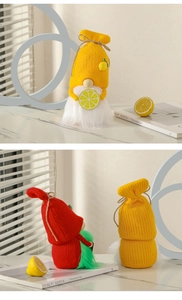 Close-up of handmade knitted lemon gnomes with wooden nose and white fur beard details